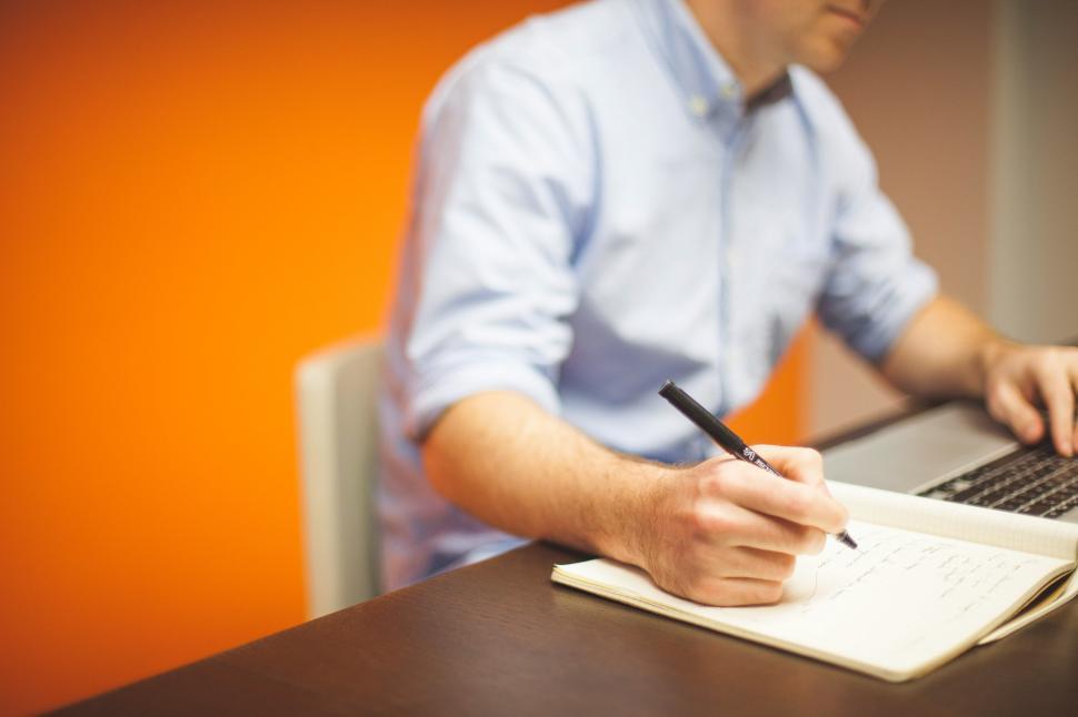 Man budgeting in a notebook